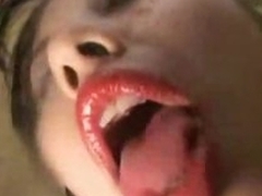 Asian chick kisses plus licks camera